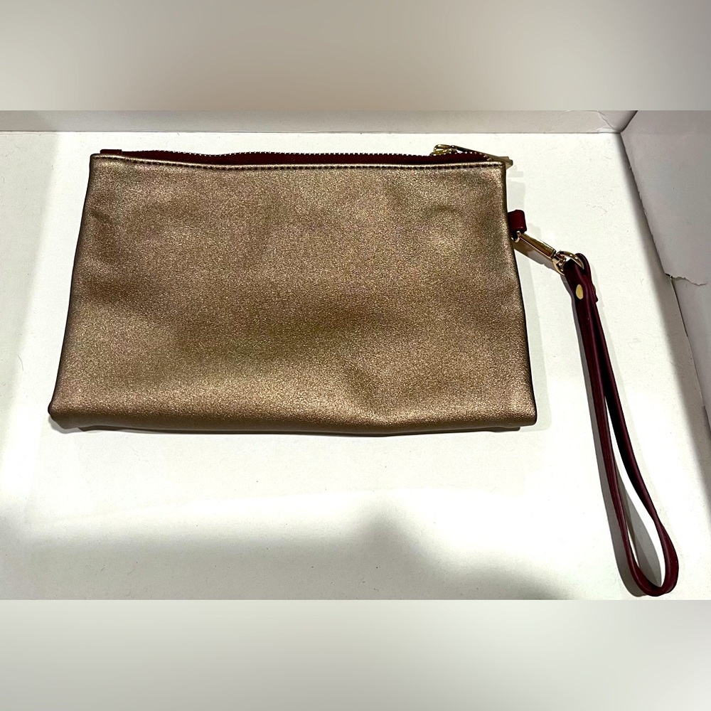 Metallic rose-gold colored clutch with magnetic snap closure. Never used!